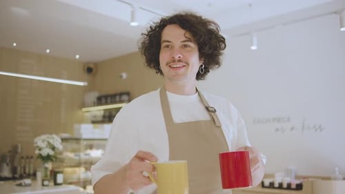 Portrait of Man Waiter a Guy Walks with Two Cups of Coffee or Tea in a Coffee Shop A Man Takes Out