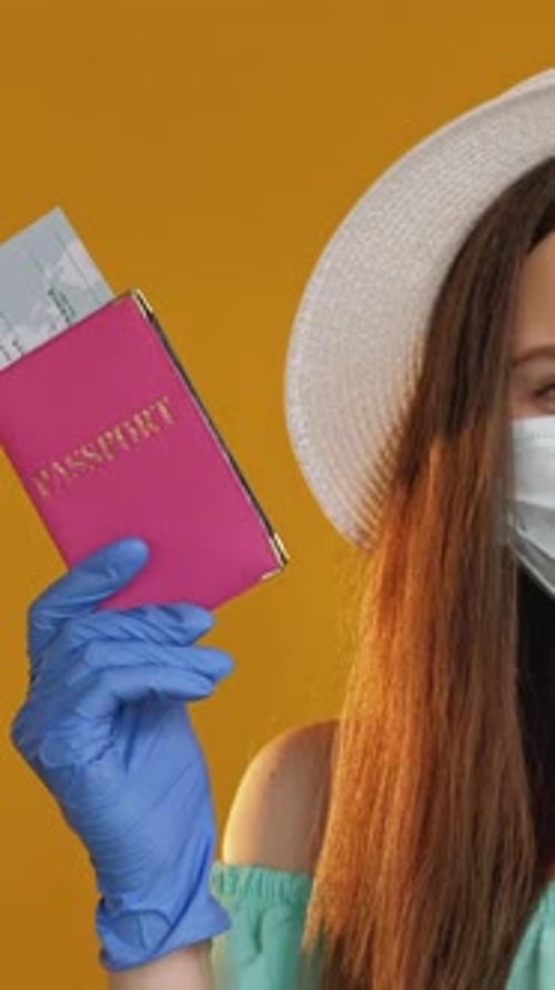 Young Adult Holding Passport Wearing Facemask