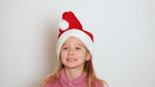 Smiling Child Wearing Santa Hat indoors