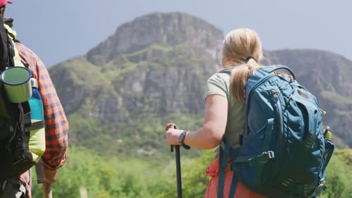Couple Hiking with Backpacks in Mountain Landscape