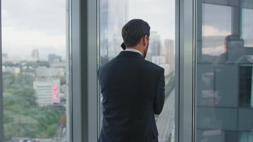 Worried Man Finish Call Standing Near Office Window Closeup