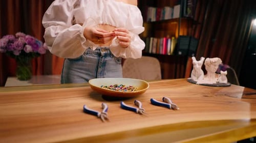 Woman Making Jewelry with Beads and Pliers