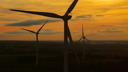 Wind Turbines Rotating at Sunset in Rural Setting