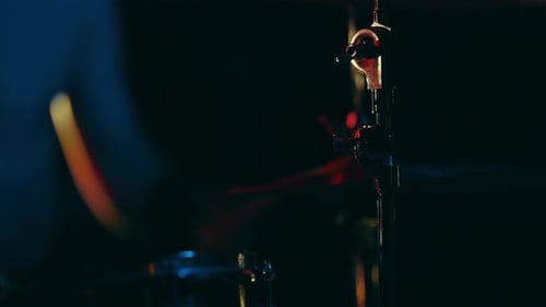 Close Up Drummer Playing Drum Set in Dark