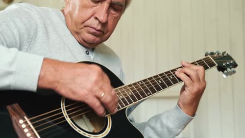 Senior Man Playing Acoustic Guitar Close Up