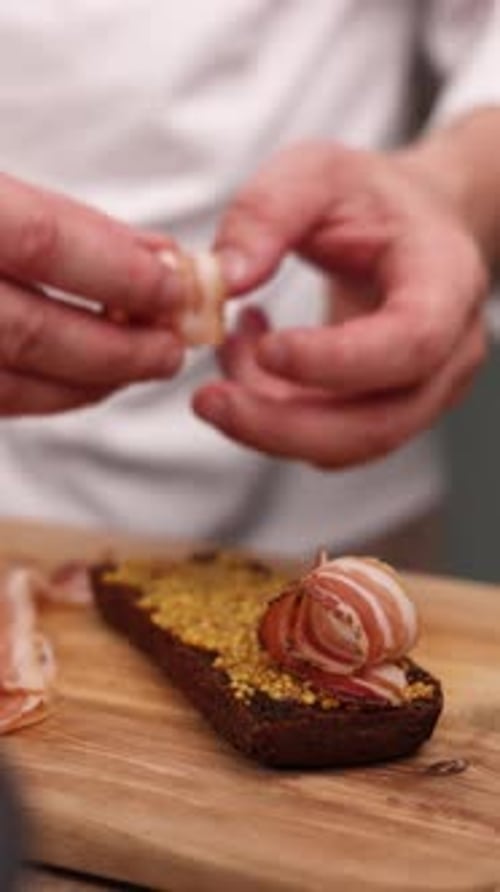 The chef is preparing a sandwich in the kitchen. Close-up
