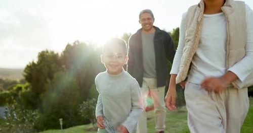 Fun, nature and grandparents walking with their grandchildren in a park on a family vacation