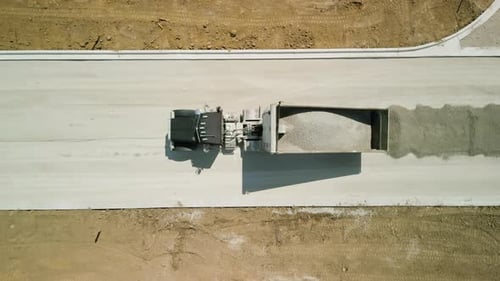 Construction Truck Tipping Dumping Gravel on Road Construction Site Aerial Footage