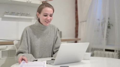 Smiling Woman Works on Laptop at Home