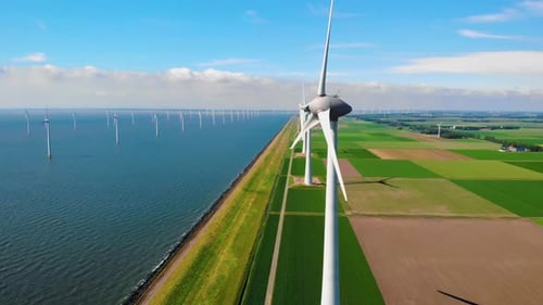 Windmill Turbines at Sea Seen From a Drone Aerial View From Above at a Huge Winmill Park