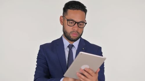Portrait of Young Hispanic Businessman Using Digital Tablet on White Background