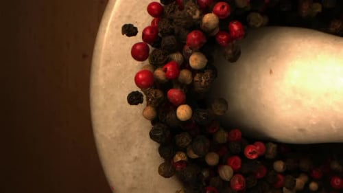 Peppercorns Flying Up from Mortar in Slow Motion