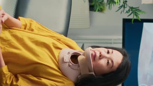 Woman wearing neck brace in a medical setting