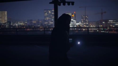 Urban Night Explorer with Flashlight Scans City Skyline Delving Into Mysterious Nightscape