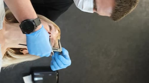 A Doctor is Preparing an Elderly Woman for Plastic Surgery on Her Face Vertical Video