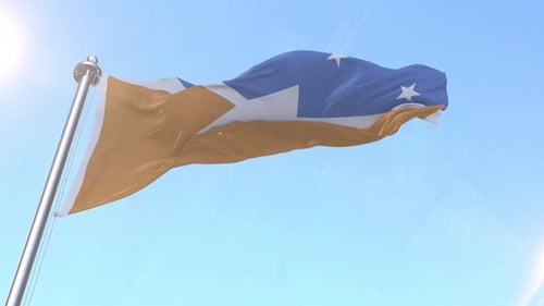 Waving Flag with Stars Against Blue Sky