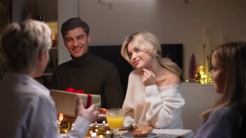 Friends Exchanging Festive Christmas Gifts Indoors