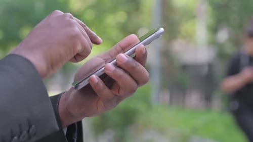 Close Up of African American Man Using Smartphone Outdoor
