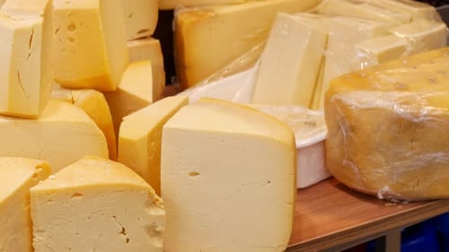 A Delicious Selection of Artisanal Cheeses Perfectly Arranged on Display for All to Enjoy