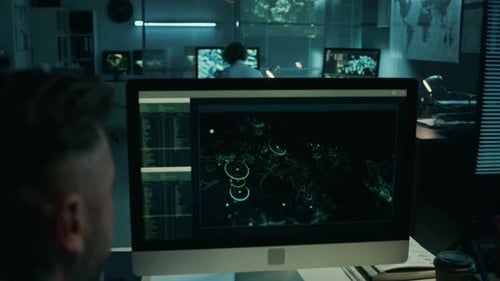 Male Reconnaissance Officer Monitoring Satellite Feed in Command Center