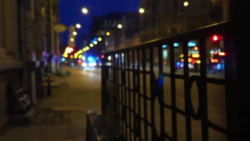 A Captivating Nighttime City Scene with Decorative Iron Railings and Vibrant Lights Illuminating the