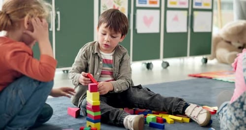 Children, student and play with blocks in class for learning, problem solving and creative activity