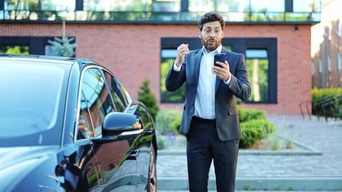 Man Celebrates Success Next to Car