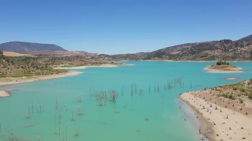 AERIAL - Man-made lake of Zahara de la Sierra, Cadiz, Spain, wide shot forward