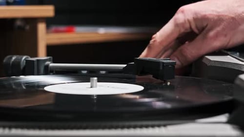Turntable Needle Drop on a Spinning Vinyl Record to Playing Music Close Up