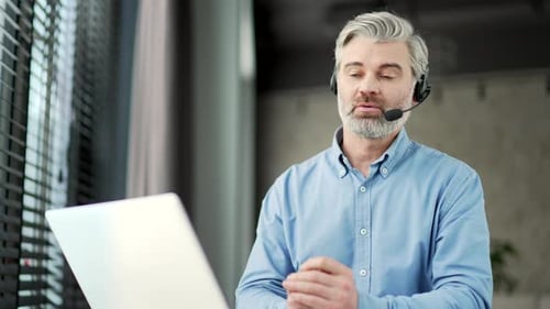 Mature Adult on Video Call in Modern Office