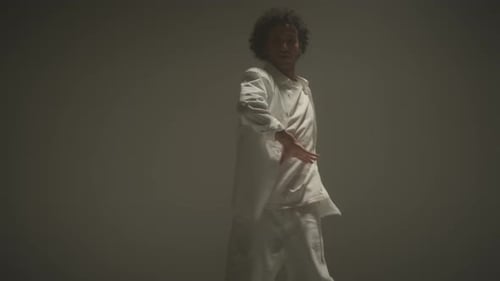 Man Dancing in Studio with Cyc Wall