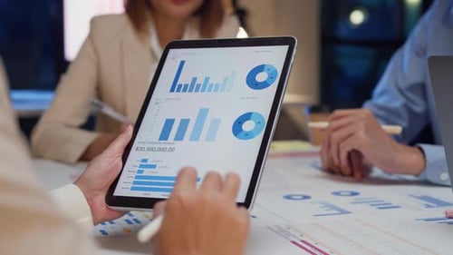 Closeup Asia businesspeople meeting brainstorming some new ideas about project at office night.