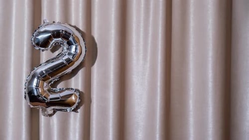 Stop Motion Happy New Year 2024 Metallic Balloons on Atlas Textile Background Greeting Card Silver