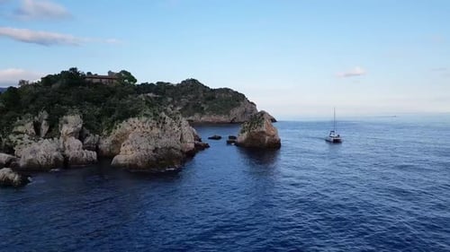 Boat On The Tranquil Bay Of Taormina In Sicily, Italy - Drone Shot