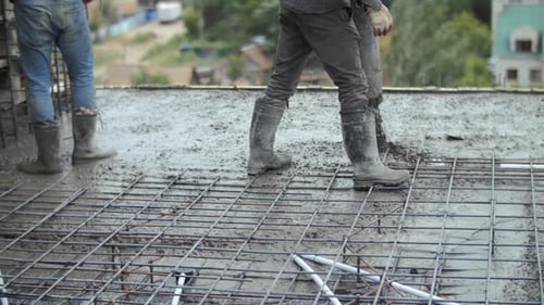 Builders Pour Concrete at a Construction Site