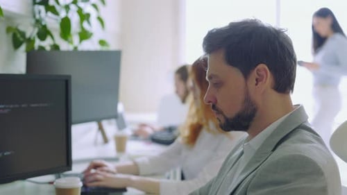 Close Up of Young Handsome IT Programmer Using to Programming Code in Control Room