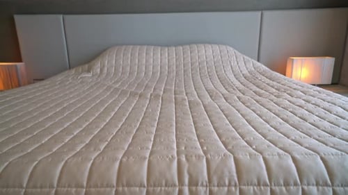 Comfortable Bed with Pillows and Bedside Tables