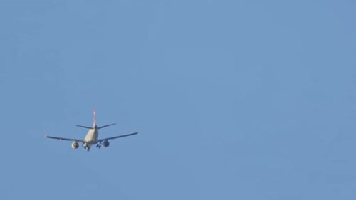 Aeroplane flying through a clear blue sky