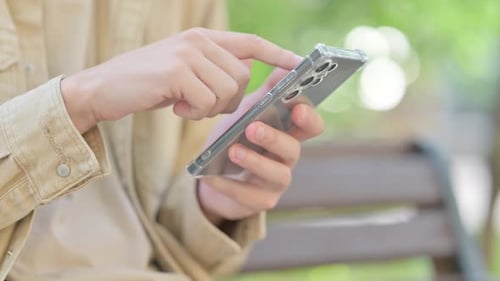 Close up of Male Hand using Smartphone Outdoor