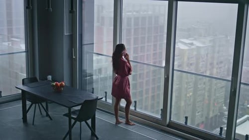 Housewife Having Phone Conversation in Panoramic Luxury Flat High Angle View