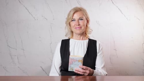Smiling Woman Holds out Passport and Money