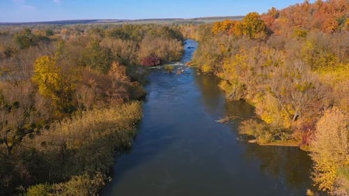 Scenery of beautiful autumn landscape. View from above of forest and autumn river