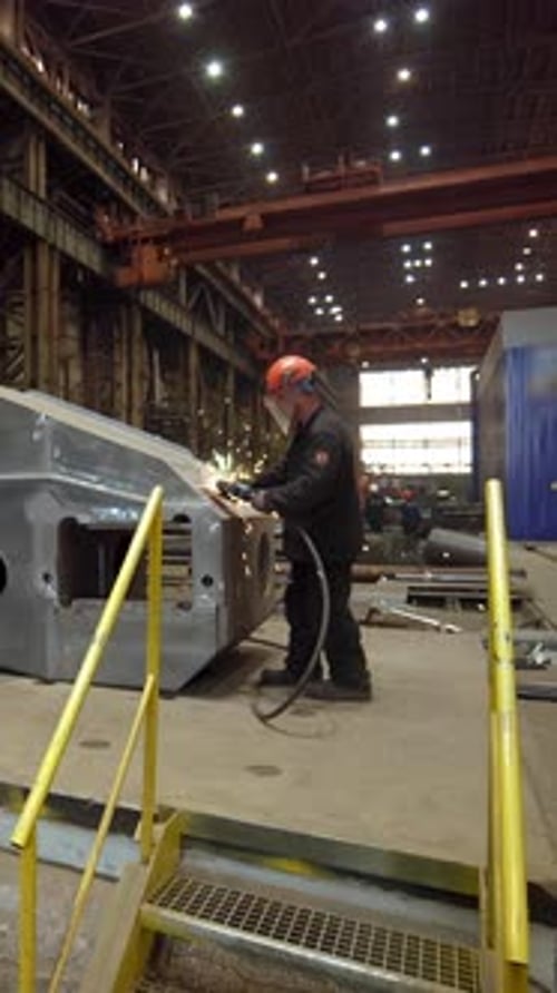 Industrial Worker Grinding Metal Part in Factory Stock Clip
