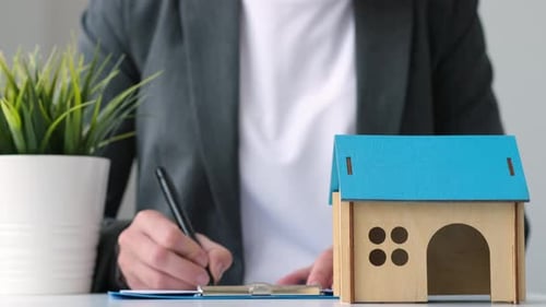 Signing Paperwork for a House in an Office