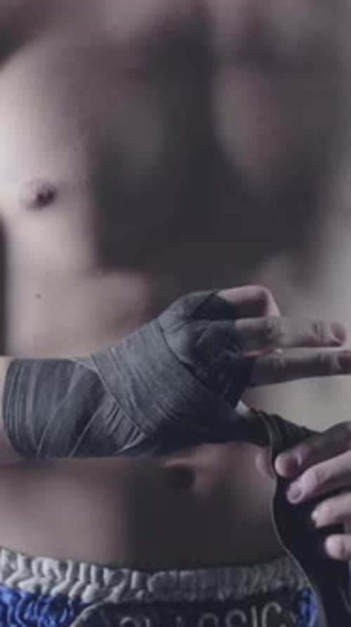 Muscular Man Wrapping Hands in Preparation