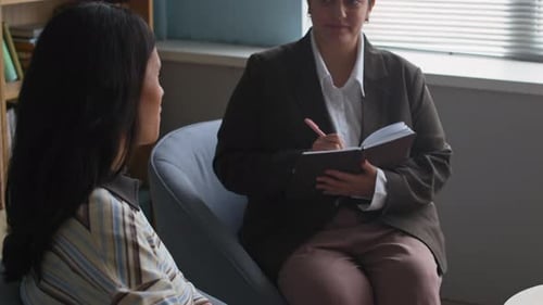 Female Psychologist Counseling Patient in Office