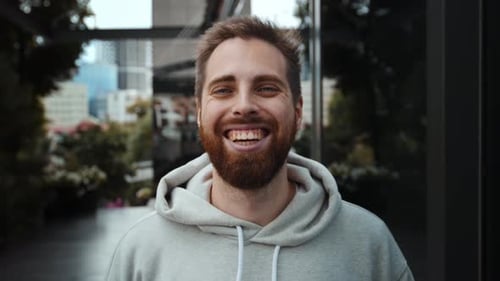 Bearded Man Smiling in Urban Setting