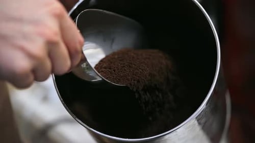 Barista mixing coffee ground traditional by hand