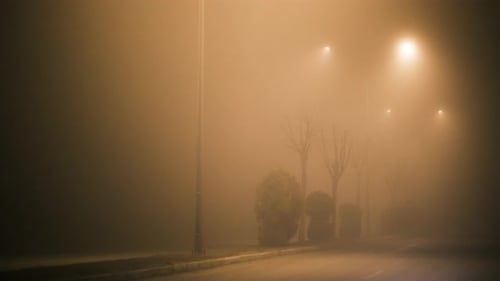 Foggy street lamps at night