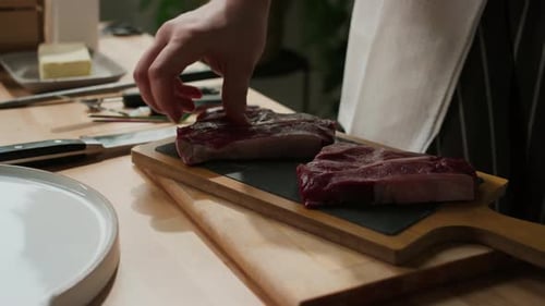 Chef Prepares Raw Meat on Cutting Board